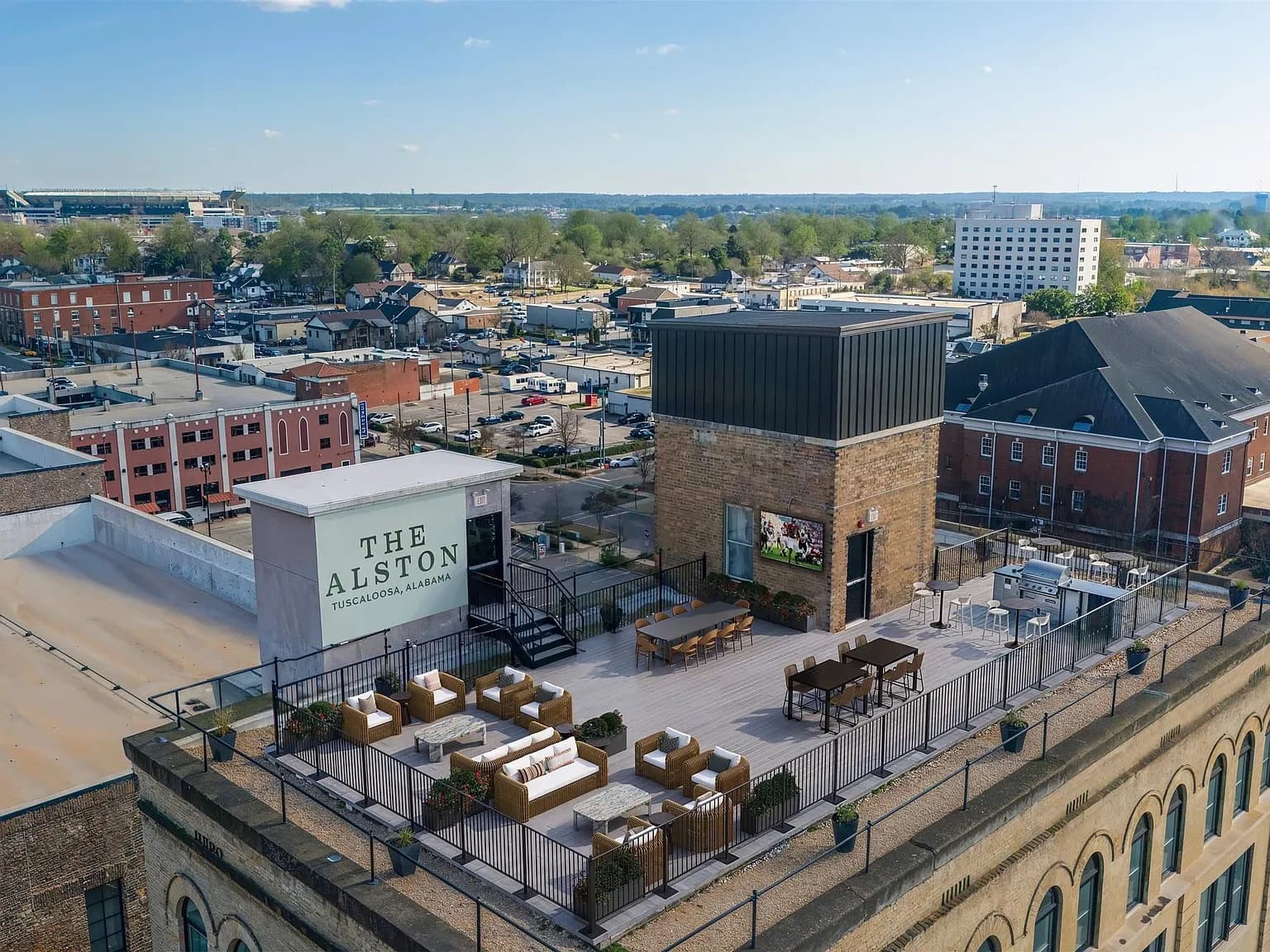 Aerial view of the rooftop terrace at The Alston, the firm's building on Greensboro Avenue, with downtown Tuscaloosa behind it